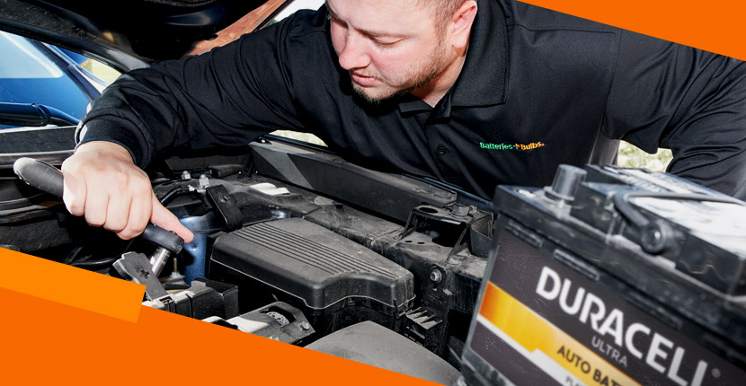 Car battery being replaced by an employee