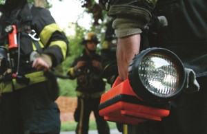 Firefighters using a work flashlight