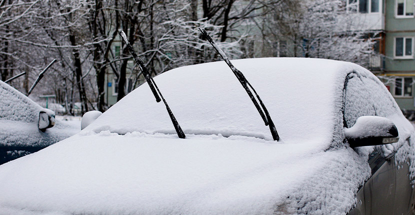 Car after a snow with the wipers up